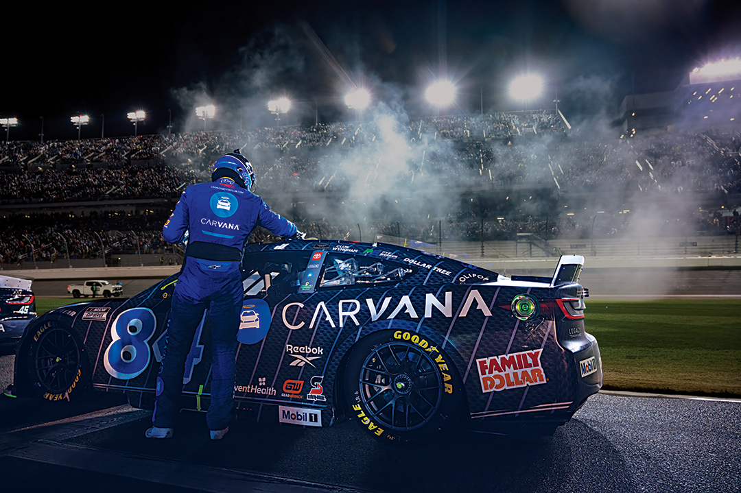 Jimmie Johnson in front of his Carvana branded NASCAR race car