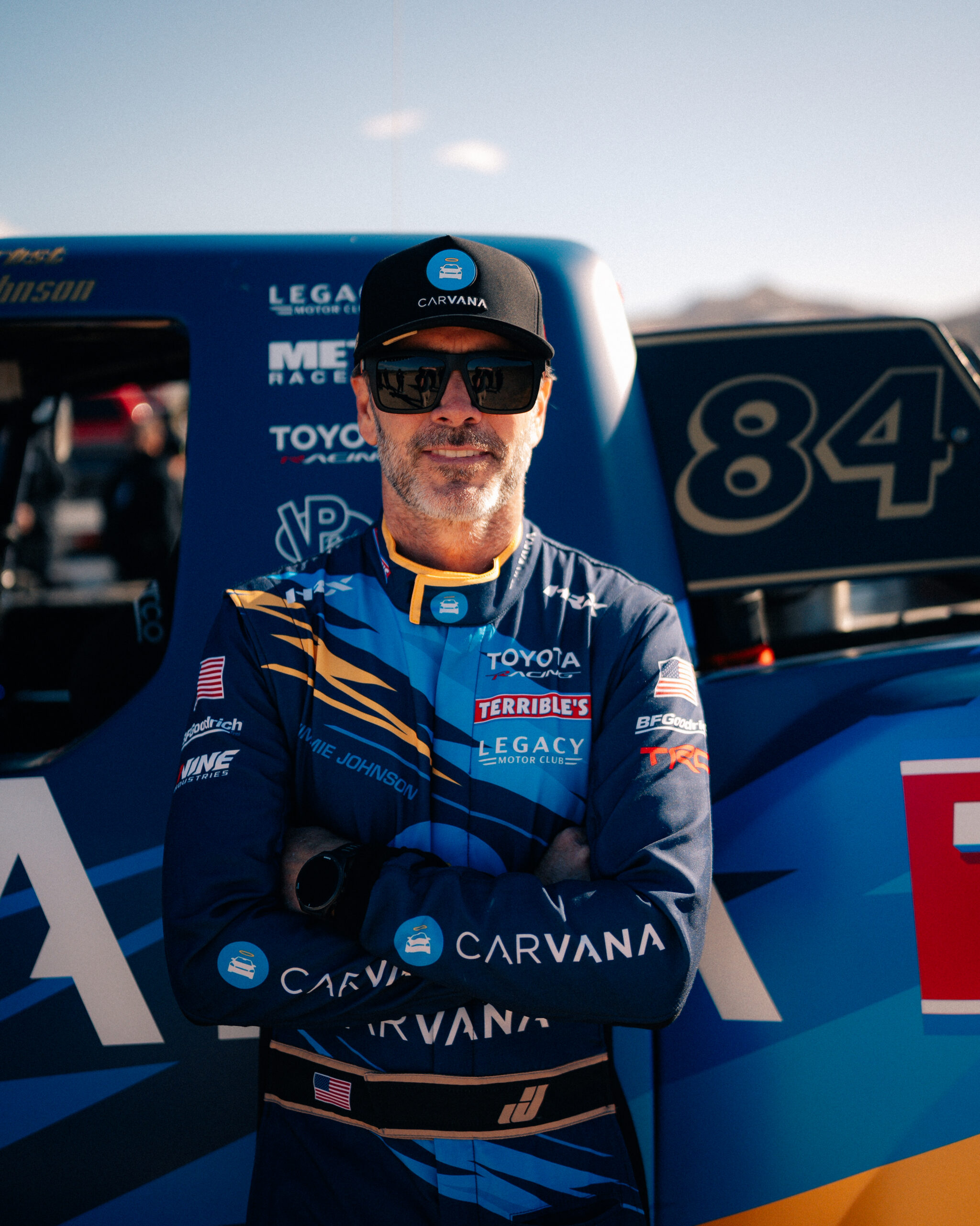 Jimmie Johnson posing in front of the Carvana-sponsored No. 84 Terrible Herbst Motorsports off-road truck at the BFGoodrich Mint 400.