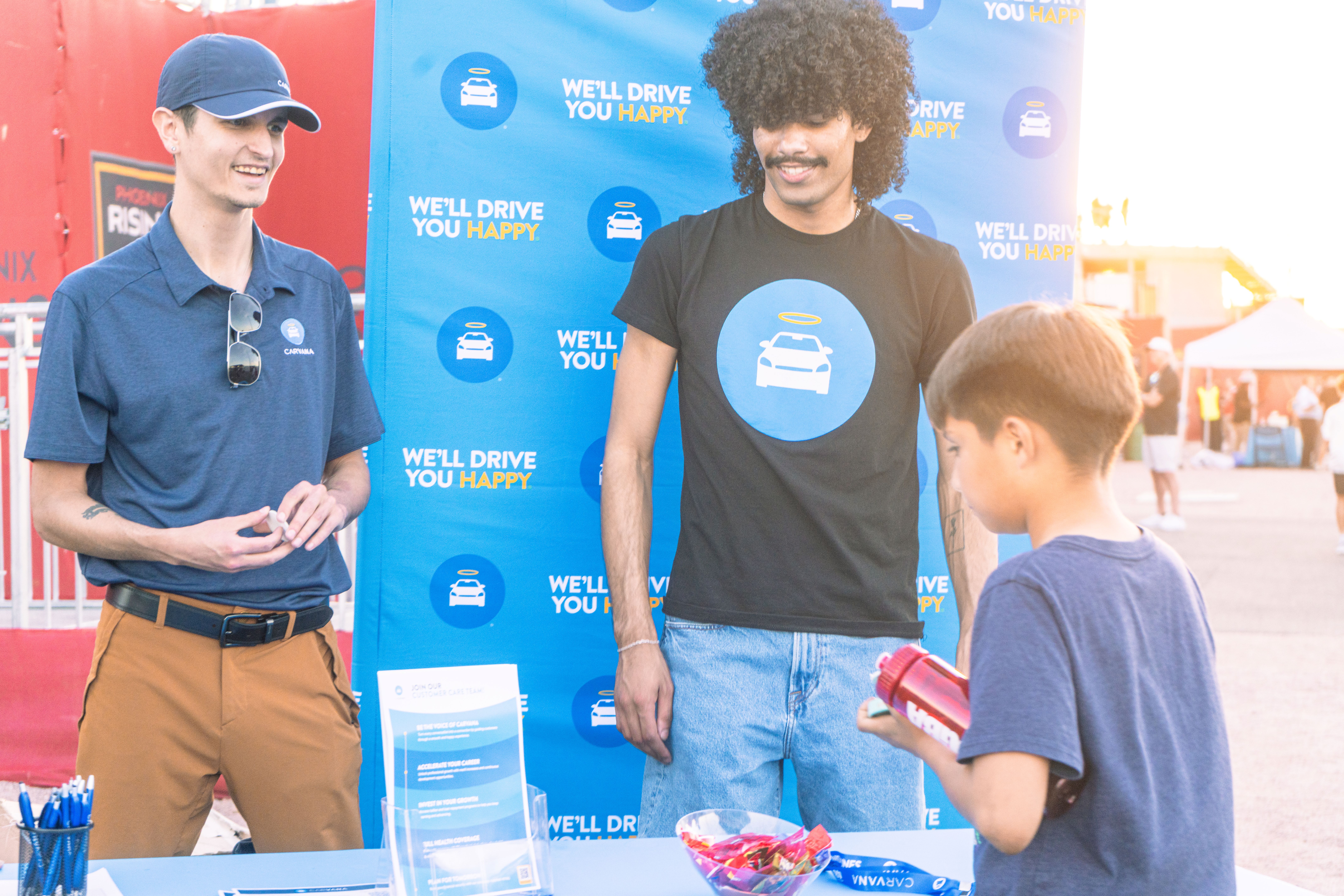 Fan visits the Carvana table with branded items before the Phoenix Rising home opener.