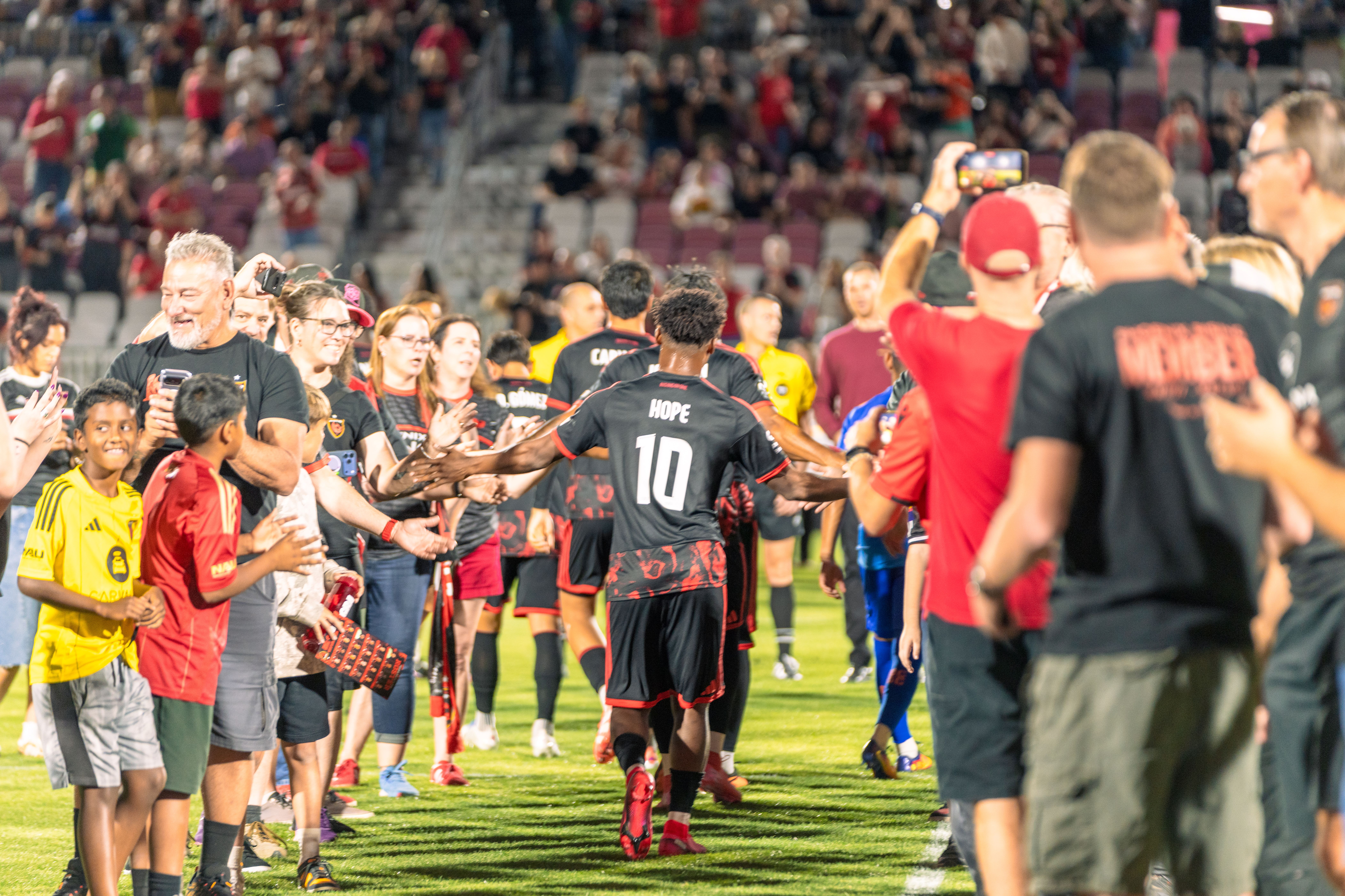 Phoenix Rising season ticket holders on field before kickoff